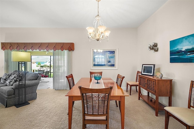 dining room with a notable chandelier and light carpet