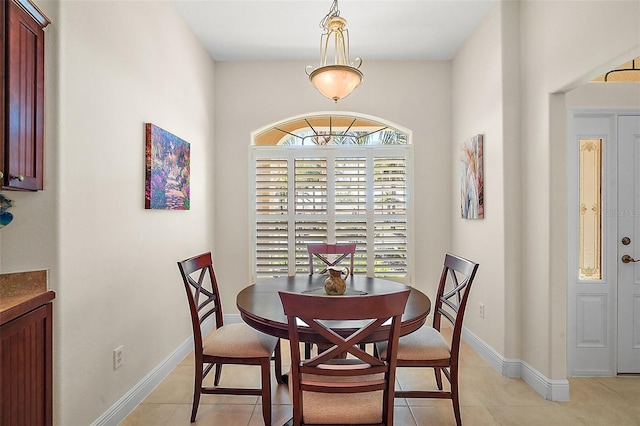 dining space featuring light tile patterned floors and baseboards