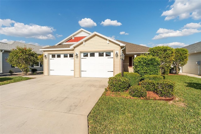 ranch-style house with a garage, roof with shingles, concrete driveway, and a front lawn