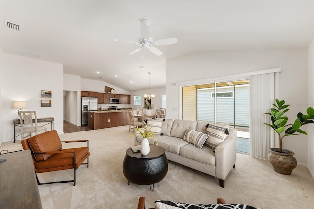 living room featuring lofted ceiling, light colored carpet, visible vents, and ceiling fan