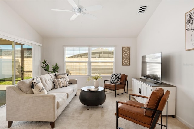 living area with a wealth of natural light, visible vents, lofted ceiling, and light carpet