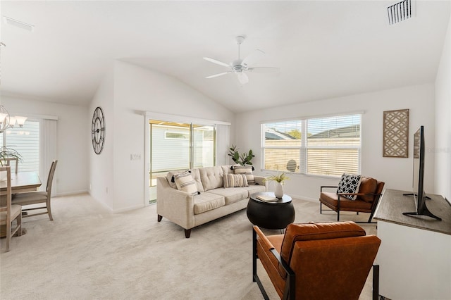 living room featuring visible vents, baseboards, light colored carpet, lofted ceiling, and ceiling fan with notable chandelier