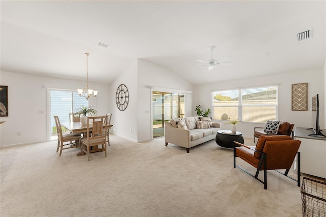 living room featuring ceiling fan with notable chandelier, vaulted ceiling, light colored carpet, and visible vents