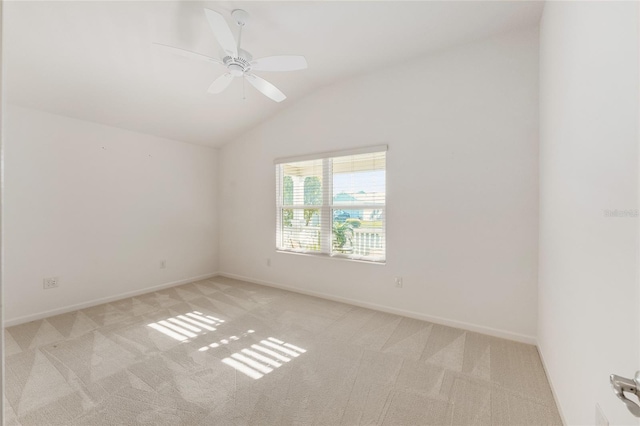 unfurnished room featuring lofted ceiling, carpet, baseboards, and ceiling fan