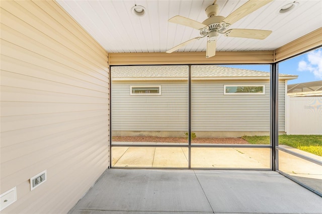 unfurnished sunroom with a ceiling fan