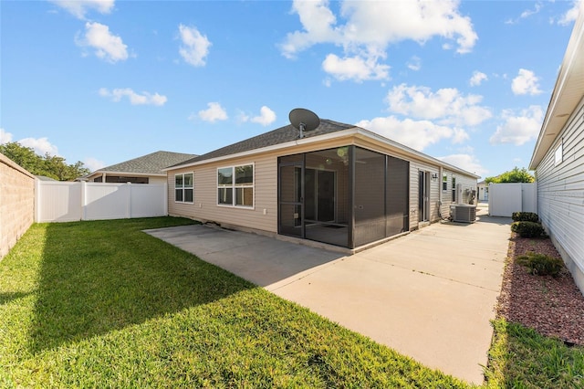 rear view of property with a patio, a fenced backyard, a lawn, and a sunroom