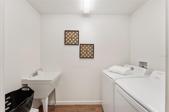 laundry area with laundry area, wood finished floors, independent washer and dryer, and baseboards