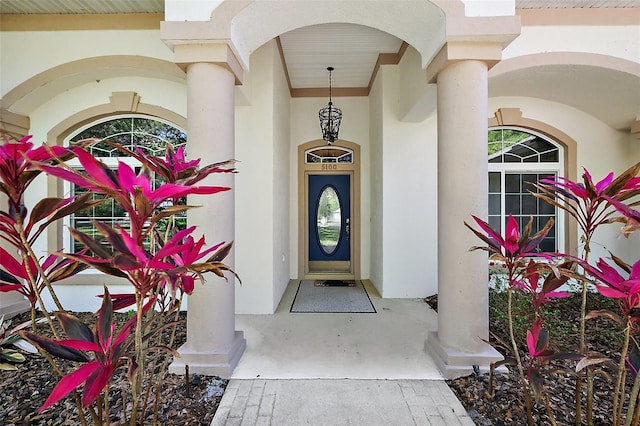 doorway to property featuring stucco siding