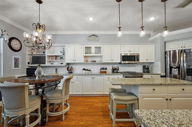 kitchen featuring visible vents, ornamental molding, stainless steel appliances, and open shelves