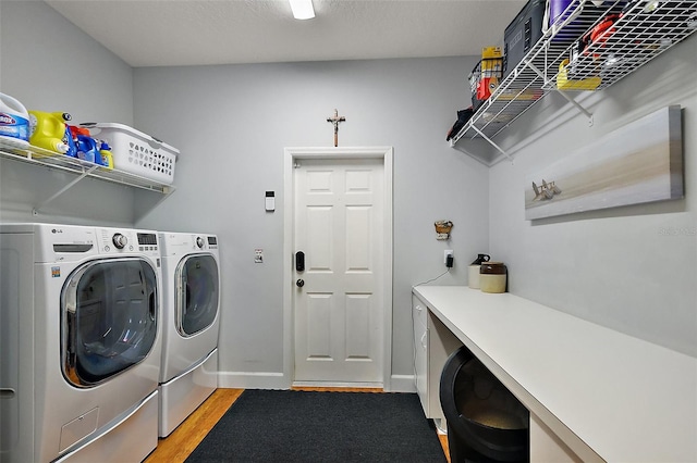 washroom featuring baseboards, light wood-style floors, independent washer and dryer, and laundry area