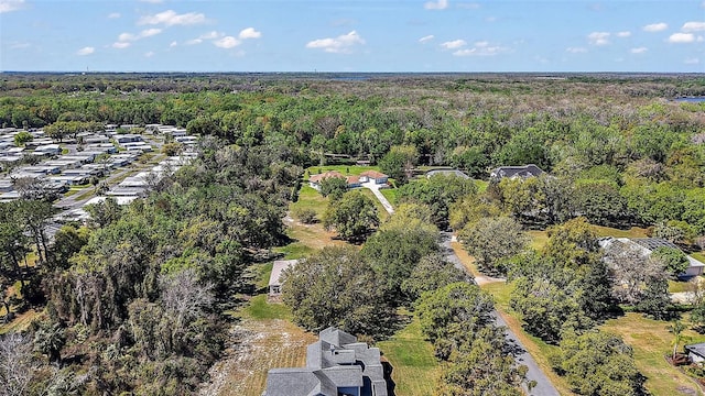 drone / aerial view featuring a wooded view