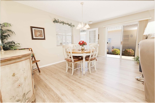 dining space featuring baseboards, a notable chandelier, and light wood-style flooring