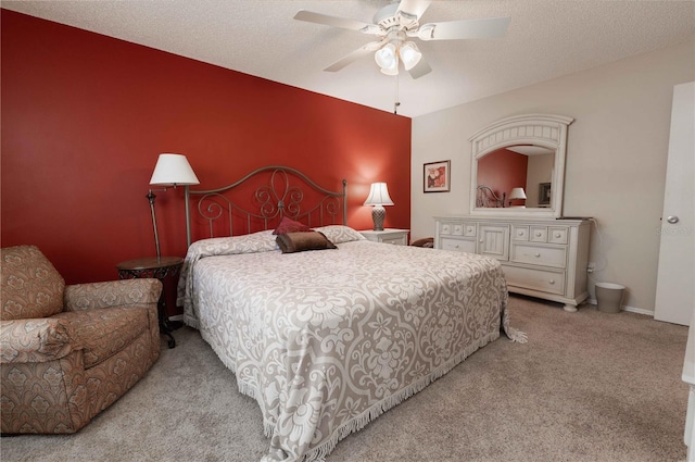 bedroom featuring carpet flooring, a textured ceiling, baseboards, and a ceiling fan