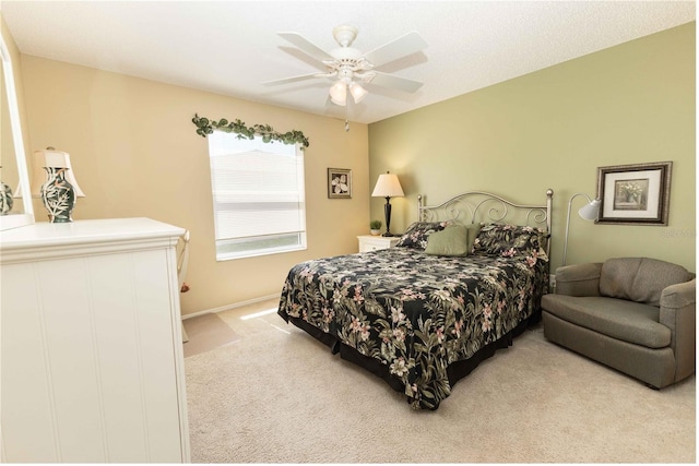 carpeted bedroom with baseboards and ceiling fan