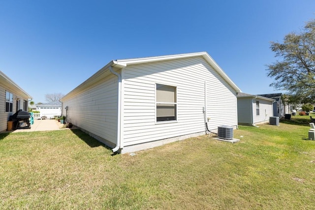 view of home's exterior with central AC and a yard