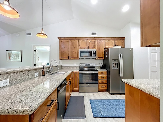 kitchen with a sink, visible vents, appliances with stainless steel finishes, and a peninsula