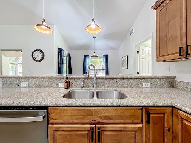 kitchen featuring visible vents, vaulted ceiling, stainless steel dishwasher, brown cabinetry, and a sink