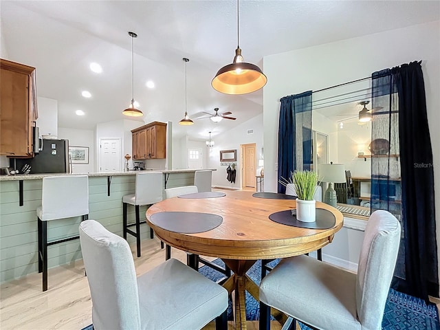 dining room featuring baseboards, lofted ceiling, recessed lighting, ceiling fan, and light wood-type flooring