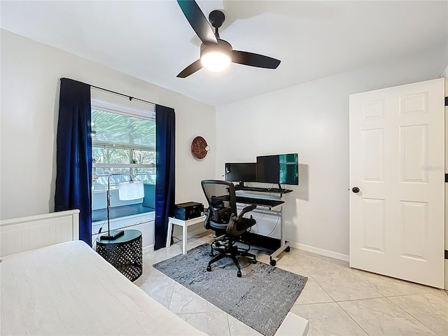 office space with baseboards, radiator, marble finish floor, and ceiling fan