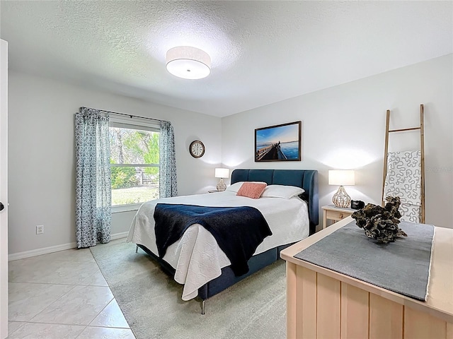 bedroom featuring baseboards and a textured ceiling