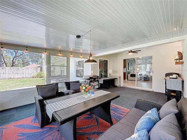 sunroom / solarium with a healthy amount of sunlight and a ceiling fan