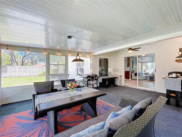 sunroom featuring a ceiling fan