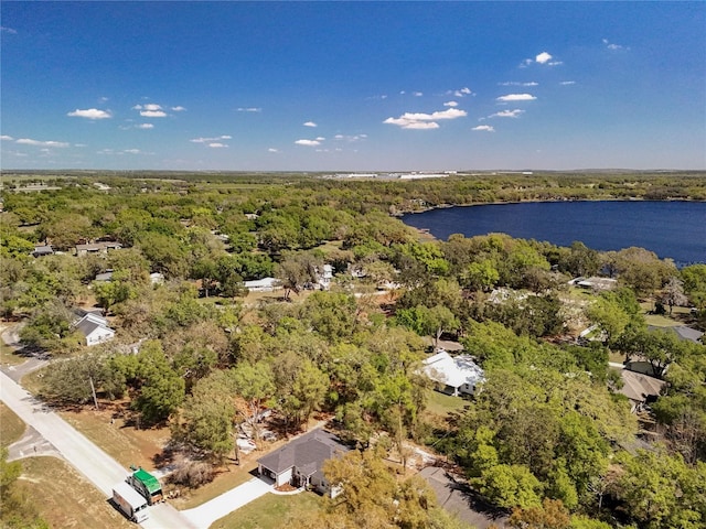 bird's eye view with a wooded view and a water view