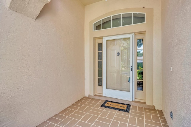 entrance to property featuring stucco siding