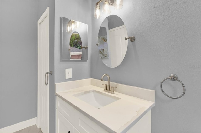 bathroom with baseboards and vanity