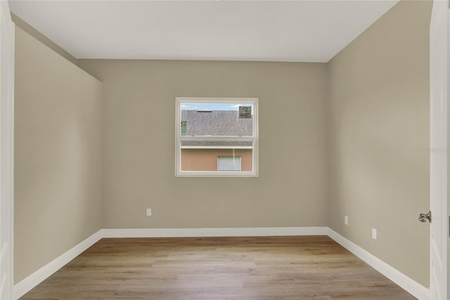 unfurnished room with light wood-style flooring and baseboards