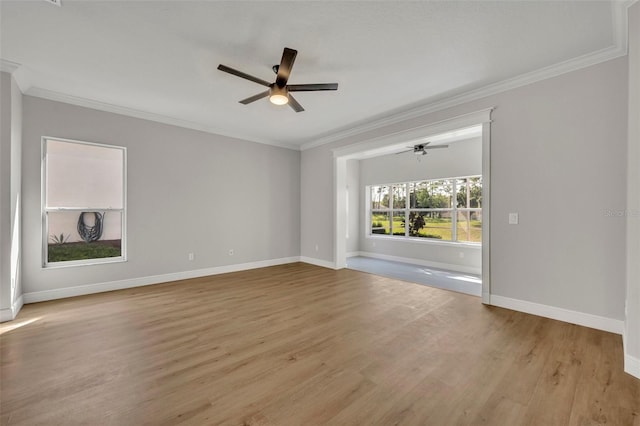 unfurnished room with baseboards, a ceiling fan, light wood-type flooring, and ornamental molding