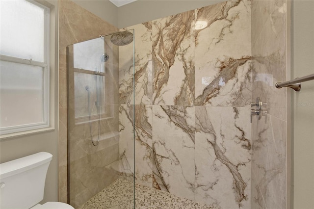 full bath with a marble finish shower and toilet