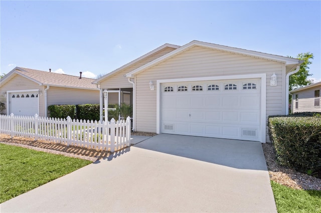 ranch-style house featuring driveway and fence