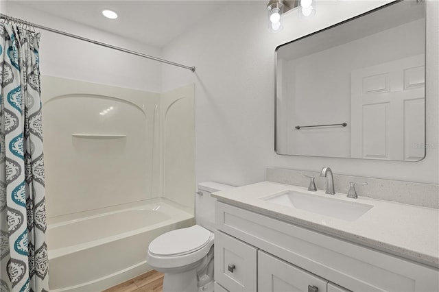 full bathroom with vanity, shower / tub combo, toilet, and wood finished floors