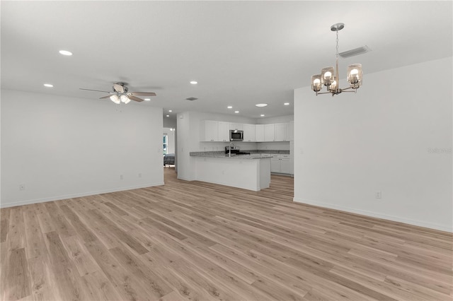 unfurnished living room with light wood-style flooring, recessed lighting, and visible vents