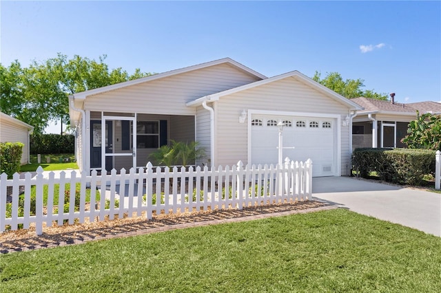 ranch-style home with driveway, a sunroom, an attached garage, and fence