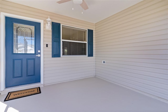 entrance to property with ceiling fan