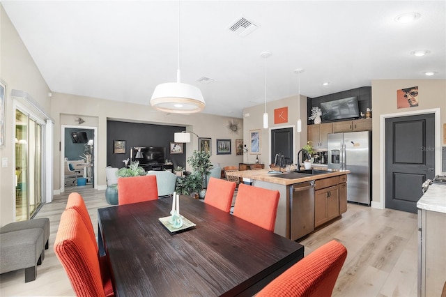 dining area featuring recessed lighting, visible vents, and light wood finished floors