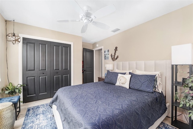 bedroom featuring a closet, visible vents, and a ceiling fan