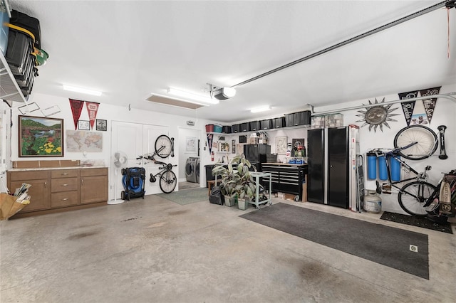 garage featuring washer / dryer and a garage door opener