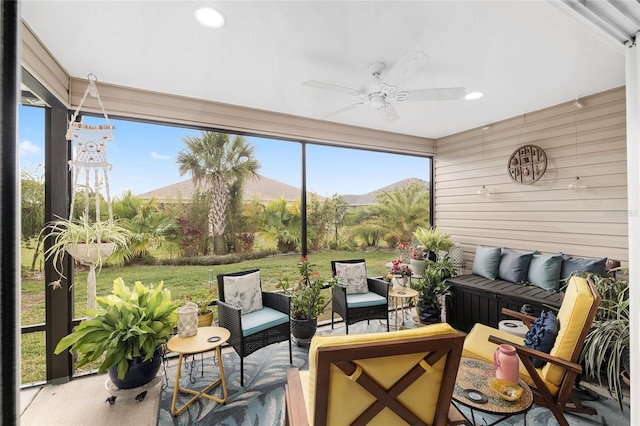 sunroom featuring a ceiling fan