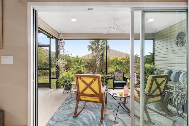 sunroom featuring a ceiling fan