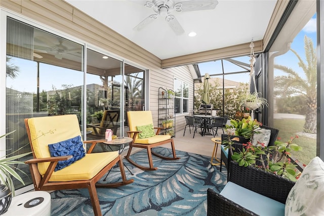 sunroom / solarium with a ceiling fan and a healthy amount of sunlight