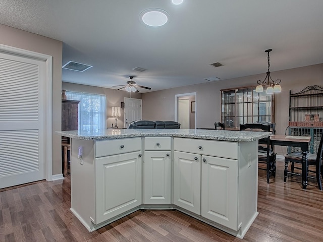 kitchen featuring a ceiling fan, dark wood-style flooring, and white cabinetry