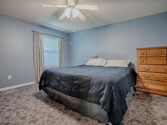 carpeted bedroom featuring baseboards, a textured ceiling, and a ceiling fan