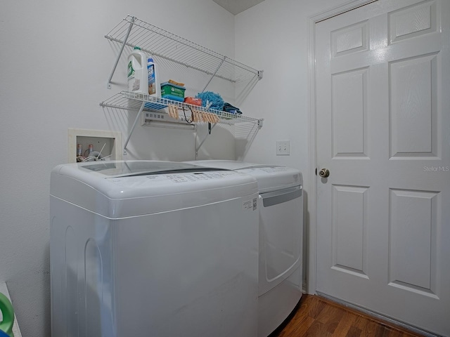 laundry room featuring laundry area, dark wood-style floors, and washing machine and clothes dryer