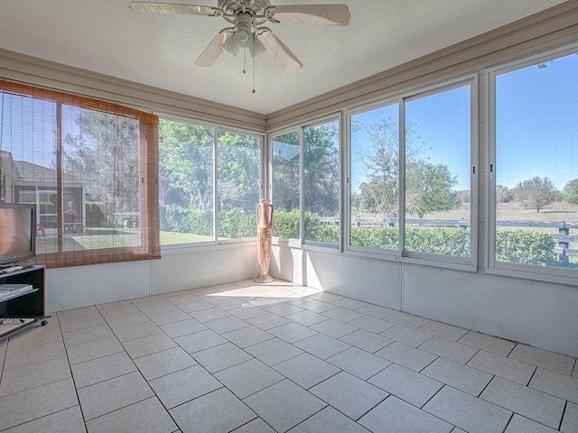 unfurnished sunroom featuring a ceiling fan