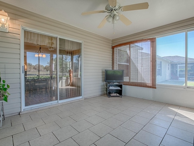 unfurnished sunroom with a ceiling fan