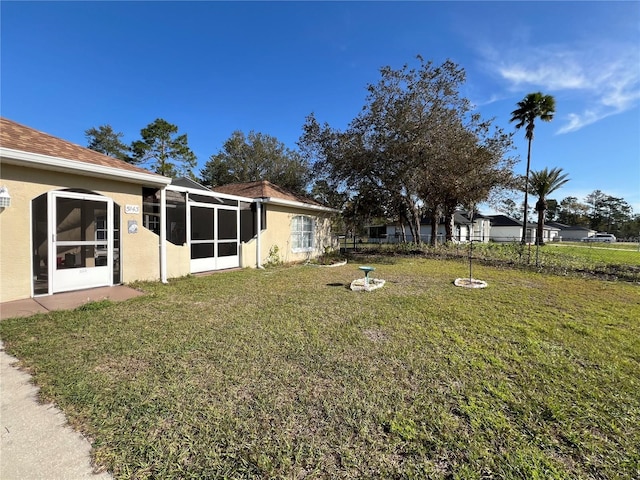 view of yard with fence and a sunroom