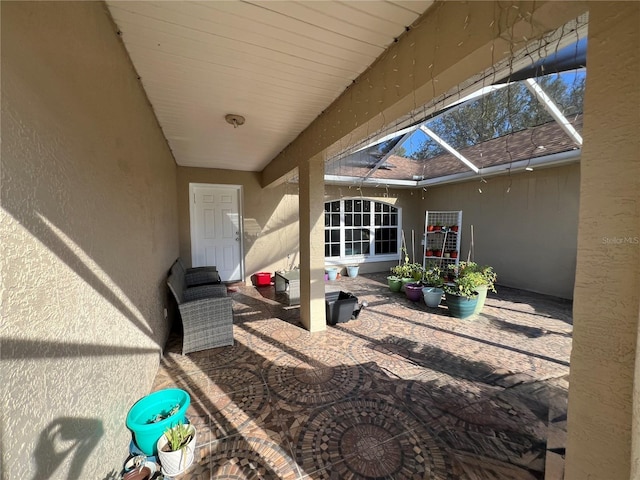 view of patio / terrace featuring glass enclosure